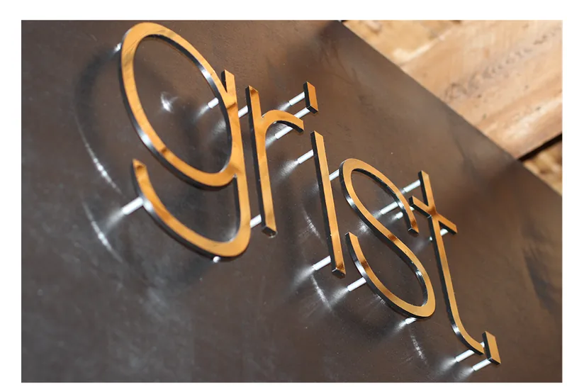 grist. dimensional metal signage installed by ninety two